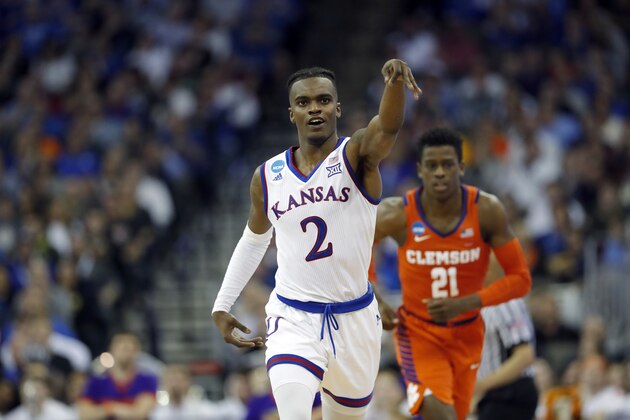 Kansas' Lagerald Vick (2) celebrates after hitting a 3-point basket as Clemson's Anthony Oliver II (21) watches during the first half of a regional semifinal game in the NCAA men's college basketball tournament Friday, March 23, 2018, in Omaha, Neb. (AP Photo/Charlie Neibergall)