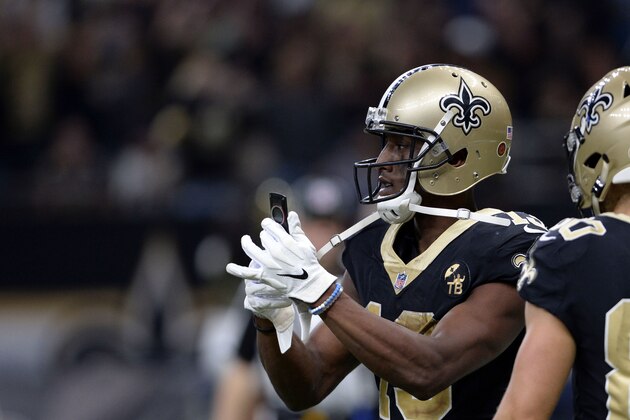 New Orleans Saints wide receiver Michael Thomas (13) pulls out a cell phone after his 72 yard touchdown reception in the second half of an NFL football game against the Los Angeles Rams in New Orleans, Sunday, Nov. 4, 2018. (AP Photo/Bill Feig)