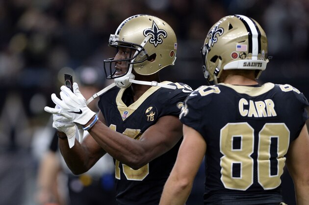 New Orleans Saints wide receiver Michael Thomas (13) pulls out a cell phone after his 72 yard touchdown reception in the second half of an NFL football game against the Los Angeles Rams in New Orleans, Sunday, Nov. 4, 2018. (AP Photo/Bill Feig)