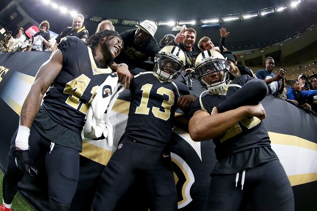 NEW ORLEANS, LA - DECEMBER 24:  Alvin Kamara #41 of the New Orleans Saints, Marshon Lattimore #23 and Michael Thomas #13 celebrate after a game against the Atlanta Falcons at the Mercedes-Benz Superdome on December 24, 2017 in New Orleans, Louisiana.  (Photo by Sean Gardner/Getty Images)