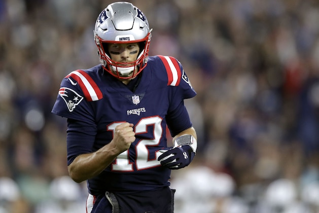 FILE - In this Oct. 4, 2018, file photo, New England Patriots quarterback Tom Brady pumps his fist after throwing a touchdown pass to Cordarrelle Patterson during the first half of an NFL football game against the Indianapolis Colts in Foxborough, Mass. A prime-time showdown between two of the league's most successful quarterbacks highlights Week 9 of the NFL season. Aaron Rodgers and the Green Bay Packers head to New England to take on Tom Brady and the Patriots. (AP Photo/Charles Krupa, File)