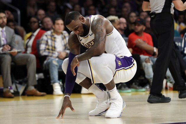 Los Angeles Lakers' LeBron James kneels after a foul is called against the Lakers during the second half of an NBA basketball game against the Toronto Raptors Sunday, Nov. 4, 2018, in Los Angeles. (AP Photo/Marcio Jose Sanchez)