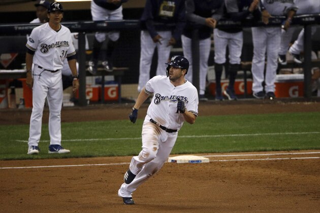 Milwaukee Brewers' Mike Moustakas (18) runs to second base after hitting an RBI double during the first inning of Game 6 of the National League Championship Series baseball game against the Los Angeles Dodgers Friday, Oct. 19, 2018, in Milwaukee. (AP Photo/Charlie Riedel)