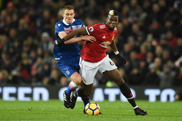 Stoke City's Scottish midfielder Darren Fletcher (L) challenges Manchester United's French midfielder Paul Pogba (R) during the English Premier League football match between Manchester United and Stoke City at Old Trafford in Manchester, north west England, on January 15, 2018. / AFP PHOTO / Oli SCARFF / RESTRICTED TO EDITORIAL USE. No use with unauthorized audio, video, data, fixture lists, club/league logos or 'live' services. Online in-match use limited to 75 images, no video emulation. No use in betting, games or single club/league/player publications.  /         (Photo credit should read OLI SCARFF/AFP/Getty Images)