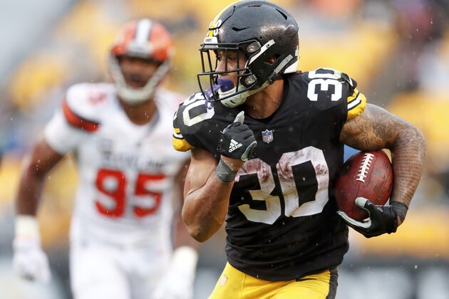 Pittsburgh Steelers running back James Conner (30) breaks away from Cleveland Browns defensive end Myles Garrett (95) for a touchdown in the second half of an NFL football game, Sunday, Oct. 28, 2018, in Pittsburgh. (AP Photo/Don Wright)