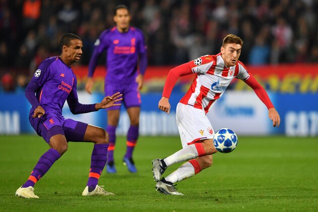 Red Star Belgrade's Serbian forward Milan Pavkov (C) vies for the ball with Liverpool's Cameroonian defender Joel Matip   during the UEFA Champions League Group C second-leg football match between Red Star Belgrade and Liverpool FC at the Rajko Mitic Stadium in Belgrade on November 6, 2018. (Photo by Andrej ISAKOVIC / AFP)        (Photo credit should read ANDREJ ISAKOVIC/AFP/Getty Images)