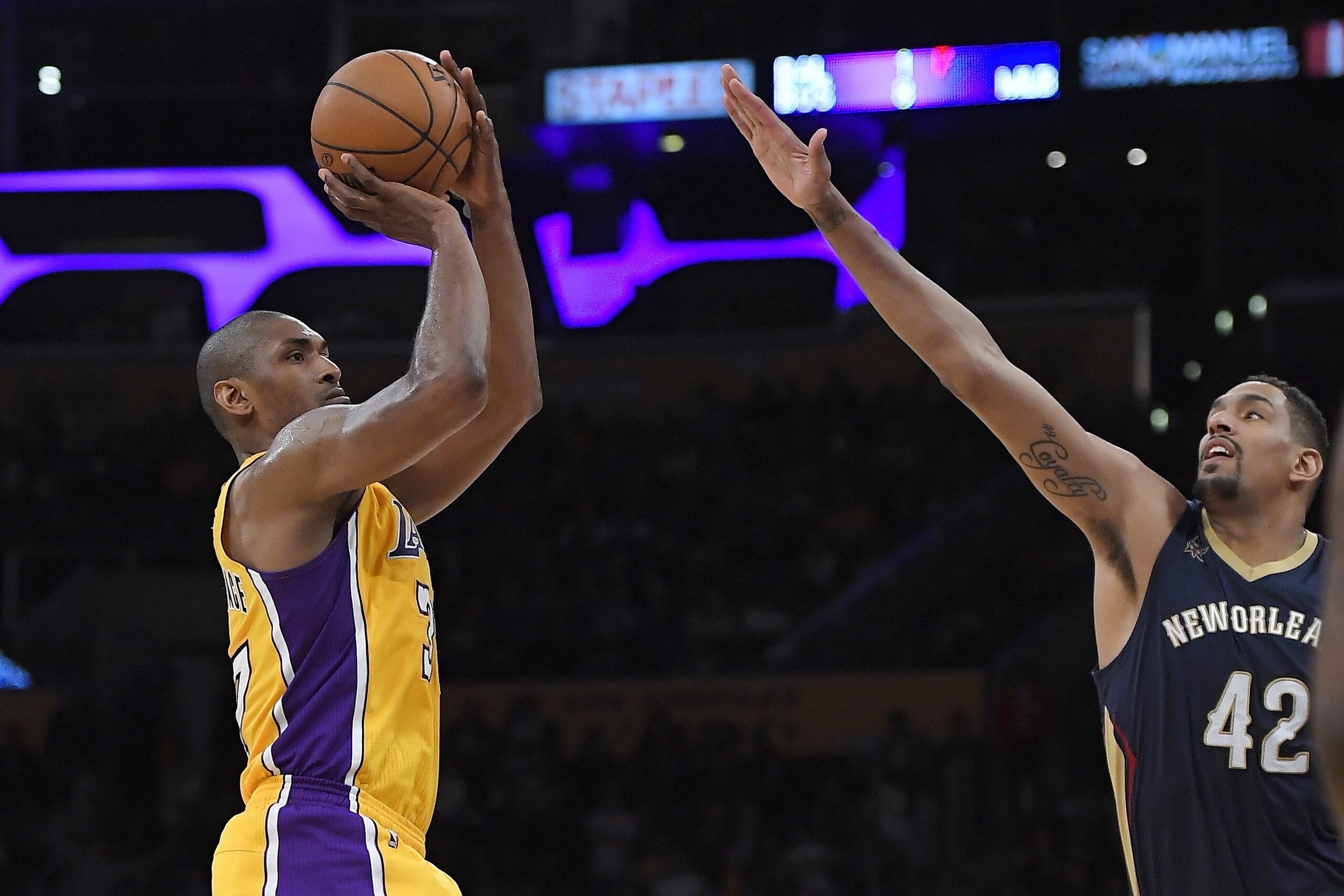 Los Angeles Lakers forward Metta World Peace shoots as New Orleans Pelicans center Alexis Ajinca defends during the second half of an NBA basketball game, Tuesday, April 11, 2017, in Los Angeles. The Lakers won 108-96. (AP Photo/Mark J. Terrill)