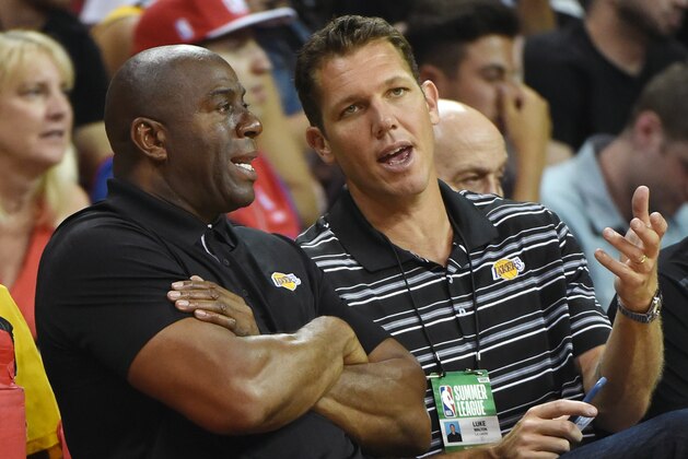 LAS VEGAS, NV - JULY 07:  Los Angeles Lakers president of basketball operations Earvin 'Magic' Johnson (L) and head coach Luke Walton of the Lakers talk during a 2017 Summer League game between the Lakers and the Los Angeles Clippers at the Thomas & Mack Center on July 7, 2017 in Las Vegas, Nevada. The Clippers won 96-93 in overtime. NOTE TO USER: User expressly acknowledges and agrees that, by downloading and or using this photograph, User is consenting to the terms and conditions of the Getty Images License Agreement.  (Photo by Ethan Miller/Getty Images)