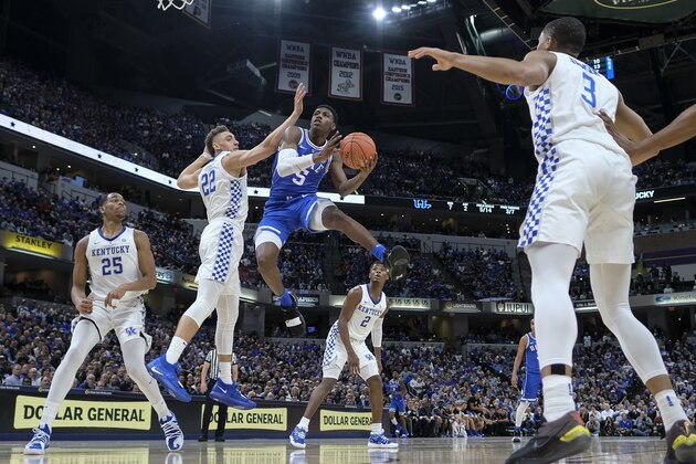 Duke forward RJ Barrett (5) shoots around Kentucky forward Reid Travis (22) during the first half of an NCAA college basketball game at the Champions Classic in Indianapolis Tuesday, Nov. 6, 2018. (AP Photo/AJ Mast)