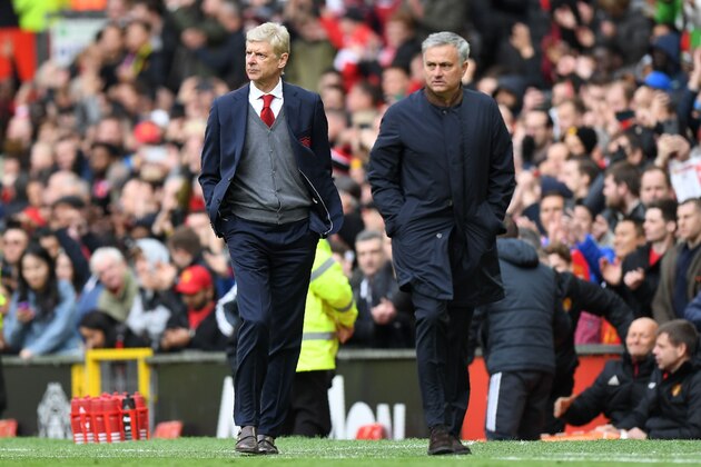 Manchester United's Portuguese manager Jose Mourinho (R) walks off with Arsenal's French manager Arsene Wenger after the English Premier League football match between Manchester United and Arsenal at Old Trafford in Manchester, north west England, on April 29, 2018. - Manchester United won the game 2-1. (Photo by Paul ELLIS / AFP) / RESTRICTED TO EDITORIAL USE. No use with unauthorized audio, video, data, fixture lists, club/league logos or 'live' services. Online in-match use limited to 75 images, no video emulation. No use in betting, games or single club/league/player publications. /         (Photo credit should read PAUL ELLIS/AFP/Getty Images)