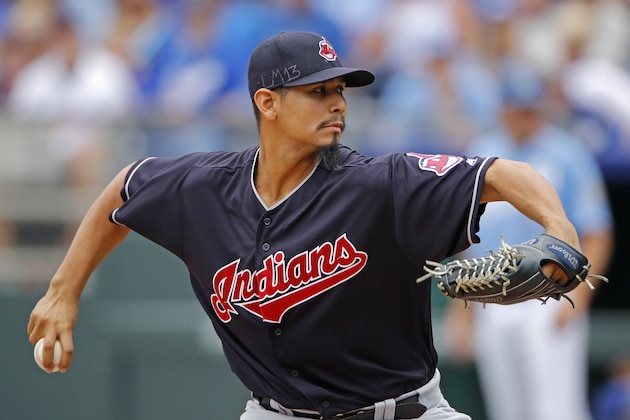 FILE - In this Sept. 30, 2018, file photo, Cleveland Indians pitcher Carlos Carrasco throws during the first inning of a baseball game against the Kansas City Royals, in Kansas City, Mo. The Indians have picked up their $9.75 million contract option on Carlos Carrasco for next season. (AP Photo/Charlie Riedel, File)
