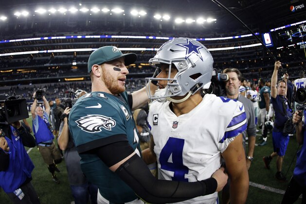 Philadelphia Eagles' Carson Wentz, left, and Dallas Cowboys' Dak Prescott, right, greet each other after their NFL football game, Sunday, Nov. 19, 2017, in Arlington, Texas. (AP Photo/Ron Jenkins)