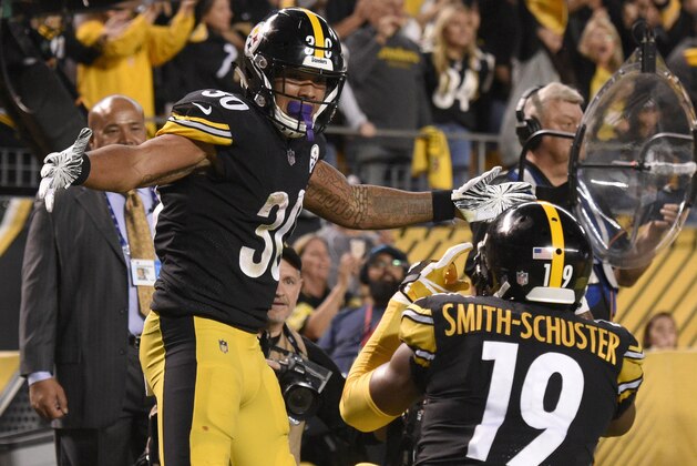 Pittsburgh Steelers running back James Conner (30) celebrates his touchdown with JuJu Smith-Schuster during the first half of an NFL football game against the Baltimore Ravens in Pittsburgh, Sunday, Sept. 30, 2018. (AP Photo/Don Wright)