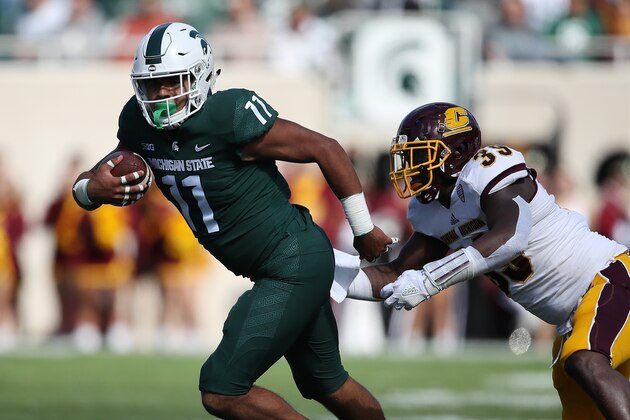 EAST LANSING, MI - SEPTEMBER 29:  Connor Heyward #11 of the Michigan State Spartans tries for extra yards after a first half catch next to Michael Oliver #39 of the Central Michigan Chippewas at Spartan Stadium on September 29, 2018 in East Lansing, Michigan. (Photo by Gregory Shamus/Getty Images)