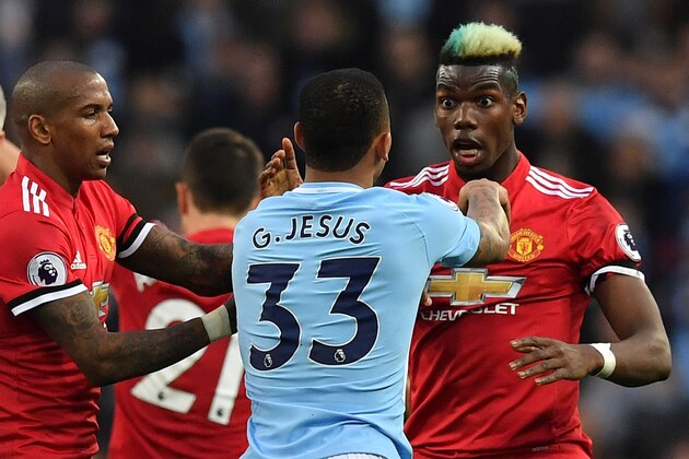 Manchester United's French midfielder Paul Pogba (R) clashes with Manchester City's Brazilian striker Gabriel Jesus after a foul on Manchester United's English midfielder Jesse Lingard by Manchester City's Brazilian midfielder Fernandinho during the English Premier League football match between Manchester City and Manchester United at the Etihad Stadium in Manchester, north west England, on April 7, 2018. / AFP PHOTO / Ben STANSALL / RESTRICTED TO EDITORIAL USE. No use with unauthorized audio, video, data, fixture lists, club/league logos or 'live' services. Online in-match use limited to 75 images, no video emulation. No use in betting, games or single club/league/player publications.  /         (Photo credit should read BEN STANSALL/AFP/Getty Images)