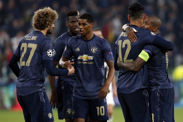 ManU players celebrate at the end of the Champions League group H soccer match between Juventus and Manchester United at the Allianz stadium in Turin, Italy, Wednesday, Nov. 7, 2018. Manchester won 2-1. (AP Photo/Antonio Calanni)