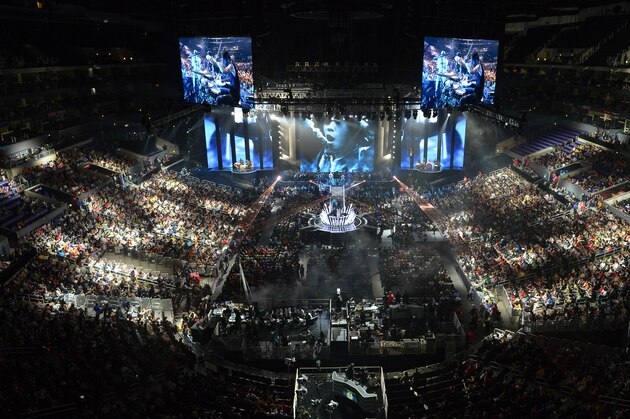 FILE - In this Oct. 4, 2013 file photo, fans watch the opening ceremony at the League of Legends Season 3 World Championship Final between South Korea's SK Telecom T1 and China's Royal Club, in Los Angeles. With millions of gamers now regularly spectating video games online and in arenas, game developers are angling to learn a few lessons from esports and possibly create the next