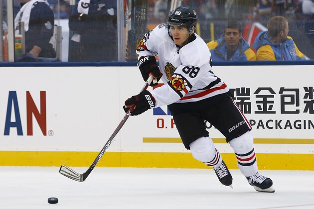 Chicago Blackhawks' Patrick Kane reaches for the puck during the second period of the NHL Winter Classic hockey game against the St. Louis Blues at Busch Stadium, Monday, Jan. 2, 2017, in St. Louis. (AP Photo/Billy Hurst)