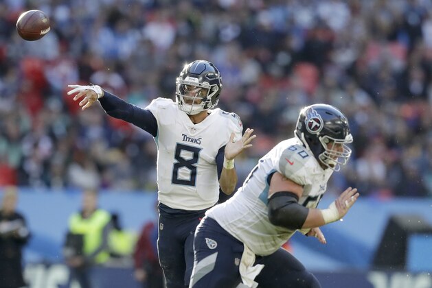 Tennessee Titans quarterback Marcus Mariota (8) passes the ball during the first half of an NFL football game against Los Angeles Chargers at Wembley stadium in London, Sunday, Oct. 21, 2018. (AP Photo/Matt Dunham)