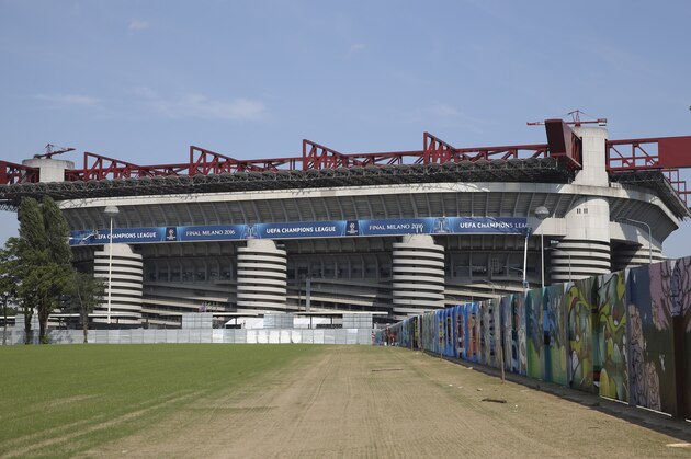A giant mural, including a black and white interpretation of 1930's Italian player Giuseppe Meazza, is painted along a wall leading towards the San Siro stadium, which officially is called the Giuseppe Meazza stadium, in Milan, Italy, Tuesday, May 17, 2016. The Champions League final between Real Madrid and Atletico Madrid will be held at the legendary soccer stadium of AC and Inter Milan, on Saturday, May 28, 2016.