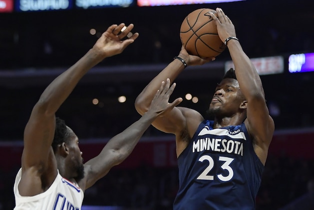 Minnesota Timberwolves guard Jimmy Butler, right, shoots as Los Angeles Clippers guard Patrick Beverley defends during the second half of an NBA basketball game, Monday, Nov. 5, 2018, in Los Angeles. The Clippers won 120-109. (AP Photo/Mark J. Terrill)