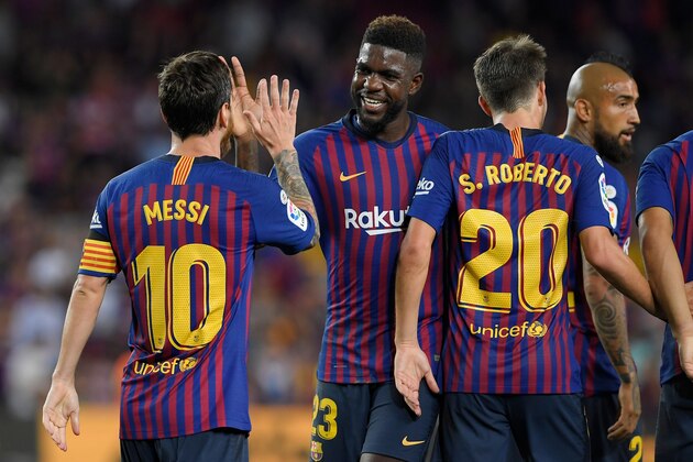 Barcelona's Argentinian forward Lionel Messi (L) celebrates with Barcelona's French defender Samuel Umtiti (2ndL) after scoring his team's third goal during the Spanish league football match between Barcelona and Alaves at the Camp Nou stadium in Barcelona on August 18, 2018. (Photo by LLUIS GENE / AFP)        (Photo credit should read LLUIS GENE/AFP/Getty Images)