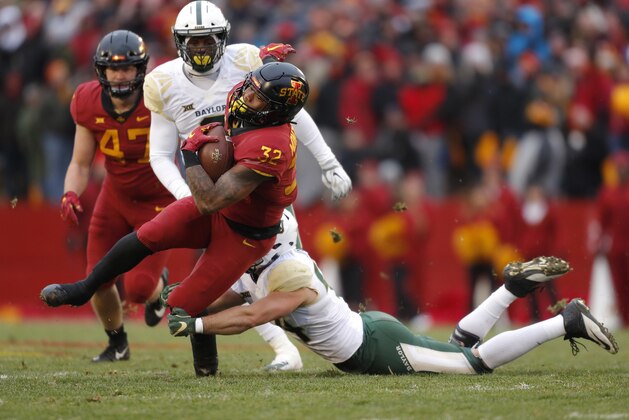 Iowa State running back David Montgomery, front left, runs the ball as he is tackled by Baylor linebacker Clay Johnston, right, during the first half of an NCAA college football game, Saturday, Nov. 10, 2018, in Ames. (AP Photo/Matthew Putney)