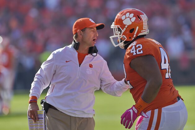 Clemson head coach Dabo Swinney speaks to Christian Wilkins during the first half of an NCAA college football game against North Carolina State Saturday, Oct. 20, 2018, in Clemson, S.C. Clemson won 41-7. (AP Photo/Richard Shiro)