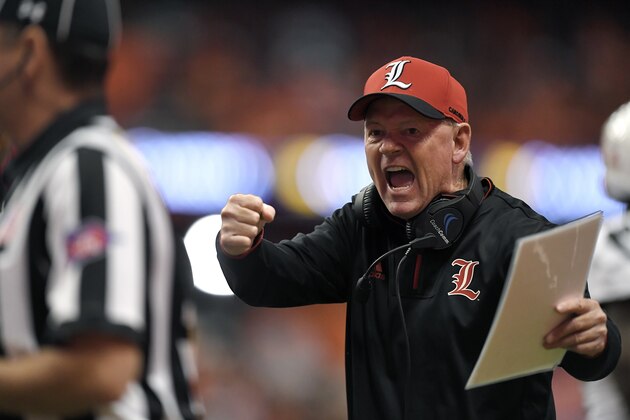 Louisville head coach Bobby Petrino tries to get the referees attention during the first half of an NCAA college football game against Syracuse in Syracuse, N.Y., Friday, Nov. 9, 2018. (AP Photo/Adrian Kraus)