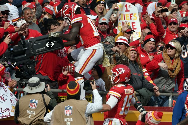 Kansas City Chiefs quarterback Patrick Mahomes (15) watches as wide receiver Tyreek Hill (10) climbs behind a television camera following his touchdown, during the first half of an NFL football game against the Arizona Cardinals in Kansas City, Mo., Sunday, Nov. 11, 2018. Hill drew a penalty on his celebration. (AP Photo/Ed Zurga)