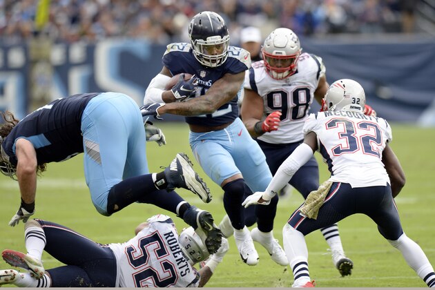 Tennessee Titans running back Derrick Henry (22) runs the ball against New England Patriots defenders Elandon Roberts (52), Trey Flowers (98) and Devin McCourty (32) in the second half of an NFL football game Sunday, Nov. 11, 2018, in Nashville, Tenn. (AP Photo/Mark Zaleski)