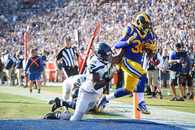 LOS ANGELES, CA - NOVEMBER 11: Running back Todd Gurley #30 of the Los Angeles Rams scores a touchdown in front of defensive end Dion Jordan #95 of the Seattle Seahawks to take a 17-14 lead in the second quarter at Los Angeles Memorial Coliseum on November 11, 2018 in Los Angeles, California. (Photo by Harry How/Getty Images)