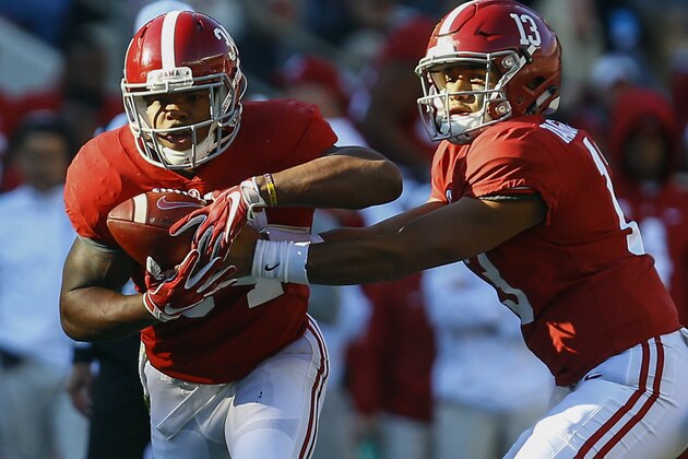 Alabama quarterback Tua Tagovailoa (13) hands off to Alabama running back Damien Harris (34) during the first half of an NCAA college football game against Mississippi State, Saturday, Nov. 10, 2018, in Tuscaloosa, Ala. (AP Photo/Butch Dill)