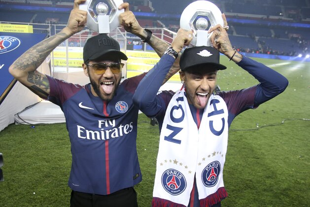 PARIS, FRANCE - MAY 12: Dani Alves aka Daniel Alves, Neymar Jr of PSG celebrate during the French Ligue 1 Championship Trophy Ceremony following the Ligue 1 match between Paris Saint-Germain (PSG) and Stade Rennais (Rennes) at Parc des Princes stadium on May 12, 2018 in Paris, France. (Photo by Jean Catuffe/Getty Images)