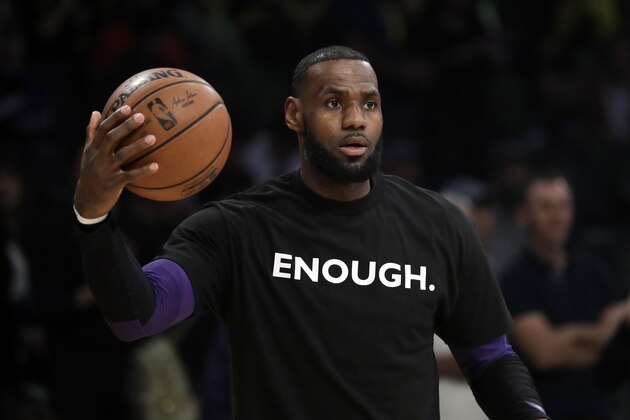 Los Angeles Lakers' LeBron James wears a t-shirt for the 12 victims of Wednesday night's shooting at a bar in Thousand Oaks, Calif., before an NBA basketball game against the Atlanta Hawks Sunday, Nov. 11, 2018, in Los Angeles. (AP Photo/Marcio Jose Sanchez)