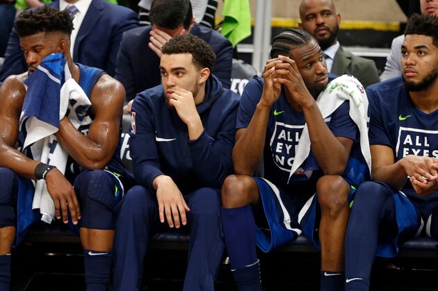 Minnesota Timberwolves players, from left, Jimmy Butler, Tyus Jones, Andrew Wiggins and Karl-Anthony Towns sit it out in final couple minutes during the second half of Game 4 in an NBA basketball first-round playoff series Monday, April 23, 2018, in Minneapolis. The Rockets won 119-100, and lead the series 3-1. (AP Photo/Jim Mone)