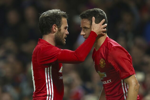 Manchester United's Juan Mata, left, celebrates with Manchester United's Ander Herrera after scoring a goal during the English League Cup soccer match between Manchester United and Manchester City at Old Trafford stadium in Manchester, England, Wednesday, Oct. 26, 2016. (AP Photo/Dave Thompson)