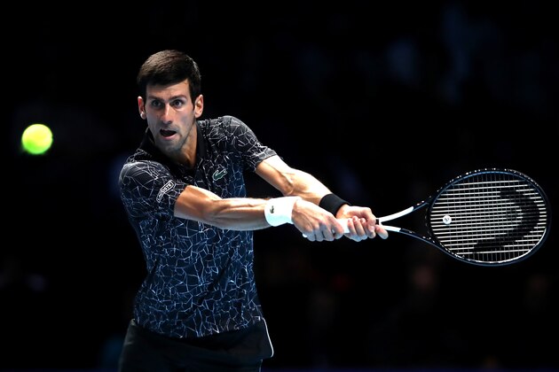 LONDON, ENGLAND - NOVEMBER 12:  Novak Djokovic of Serbia plays a backhand during his singles round robin match against John Isner of The United States during Day Two of the Nitto ATP World Tour Finals at The O2 Arena on November 12, 2018 in London, England.  (Photo by Julian Finney/Getty Images)