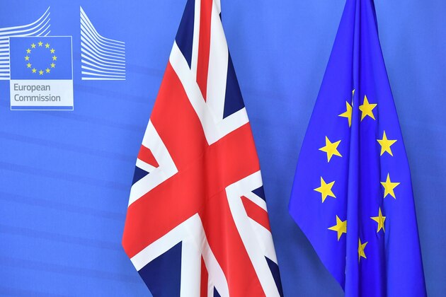 A picture taken on October 17, 2018 shows the United Kingdom (Union Jack) flag set past the EU flag before the arrival of Britain's Prime Minister Theresa May and President of the European Commission Jean-Claude Juncker at the European Commission in Brussels. - British Prime Minister Theresa May is due to address a summit of European Union leaders in which Brexit negotiations are expected to be top of the agenda. (Photo by EMMANUEL DUNAND / AFP)        (Photo credit should read EMMANUEL DUNAND/AFP/Getty Images)