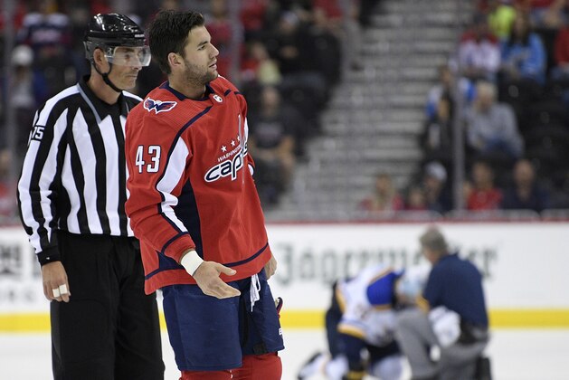 FILE - In this Sept. 30, 2018, file photo, Washington Capitals right wing Tom Wilson (43) is escorted by an official off the ice after he checked St. Louis Blues center Oskar Sundqvist, background, during the second period of an NHL preseason hockey game in Washington. Wilson has had his 20-game suspension reduced to 14 by a neutral arbitrator and is eligible to play immediately. Wilson has already served 16 games of his suspension for an illegal check to the head of St. Louis forward Oskar Sundqvist in each team’s preseason finale. The ruling by Shyam Das allows Wilson to return as soon as Tuesday night, Nov. 13, 2018, at Minnesota, and the 24-year-old will recoup $378,049 of the $1.26 million he initially forfeited as part of the suspension. (AP Photo/Nick Wass, File)