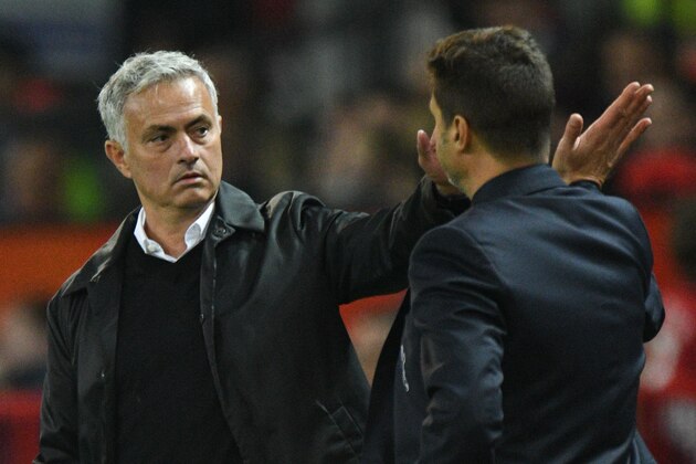 Manchester United's Portuguese manager Jose Mourinho (L) shakes hands with Tottenham Hotspur's Argentinian head coach Mauricio Pochettino (R) on the touchline towards the end of the English Premier League football match between Manchester United and Tottenham Hotspur at Old Trafford in Manchester, north west England, on August 27, 2018. (Photo by Oli SCARFF / AFP) / RESTRICTED TO EDITORIAL USE. No use with unauthorized audio, video, data, fixture lists, club/league logos or 'live' services. Online in-match use limited to 120 images. An additional 40 images may be used in extra time. No video emulation. Social media in-match use limited to 120 images. An additional 40 images may be used in extra time. No use in betting publications, games or single club/league/player publications. /         (Photo credit should read OLI SCARFF/AFP/Getty Images)