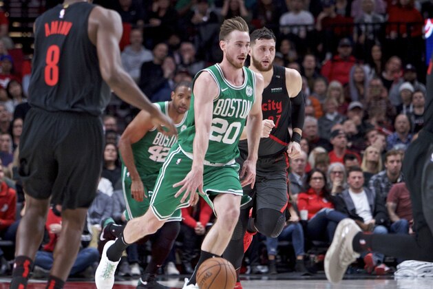 Boston Celtics forward Gordon Hayward, left, brings the ball up court in front of Portland Trail Blazers center Jusuf Nurkic during the second half of an NBA basketball game in Portland, Ore., Sunday, Nov. 11, 2018. The Trail Blazers won 100-94. (AP Photo/Craig Mitchelldyer)