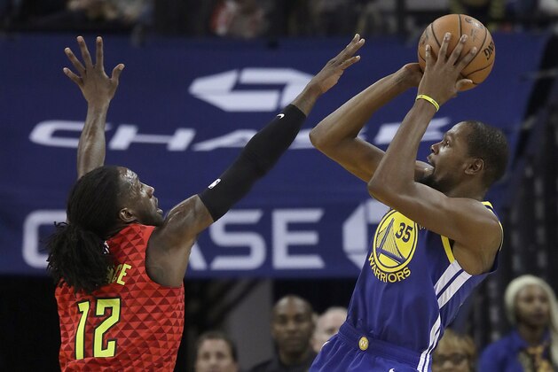 Golden State Warriors forward Kevin Durant (35) shoots against Atlanta Hawks forward Taurean Prince (12) during the first half of an NBA basketball game in Oakland, Calif., Tuesday, Nov. 13, 2018. (AP Photo/Jeff Chiu)