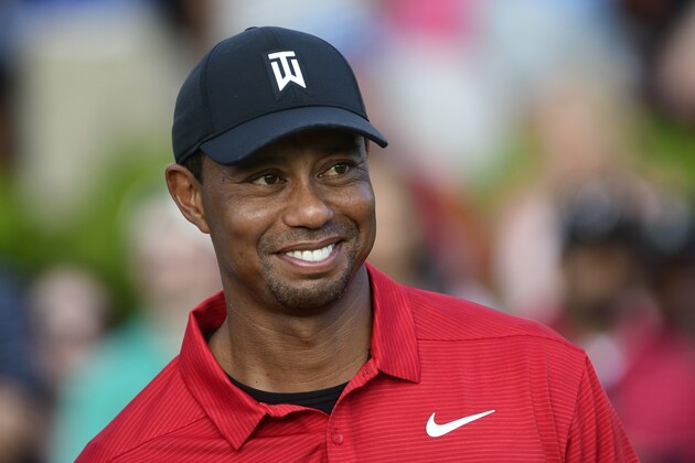 Tiger Woods stands on the 18th green after winning the Tour Championship golf tournament Sunday, Sept. 23, 2018, in Atlanta. (AP Photo/John Amis)