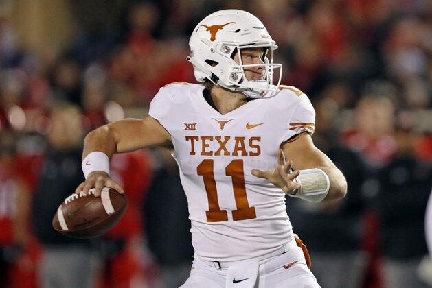 Texas' Sam Ehlinger (11) looks to pass the ball during the first half of an NCAA college football game against Texas Tech, Saturday, Nov. 10, 2018, in Lubbock, Texas. (AP Photo/Brad Tollefson)