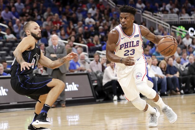 Philadelphia 76ers' Jimmy Butler (23) drives past Orlando Magic's Evan Fournier during the first half of an NBA basketball game Wednesday, Nov. 14, 2018, in Orlando, Fla. (AP Photo/John Raoux)