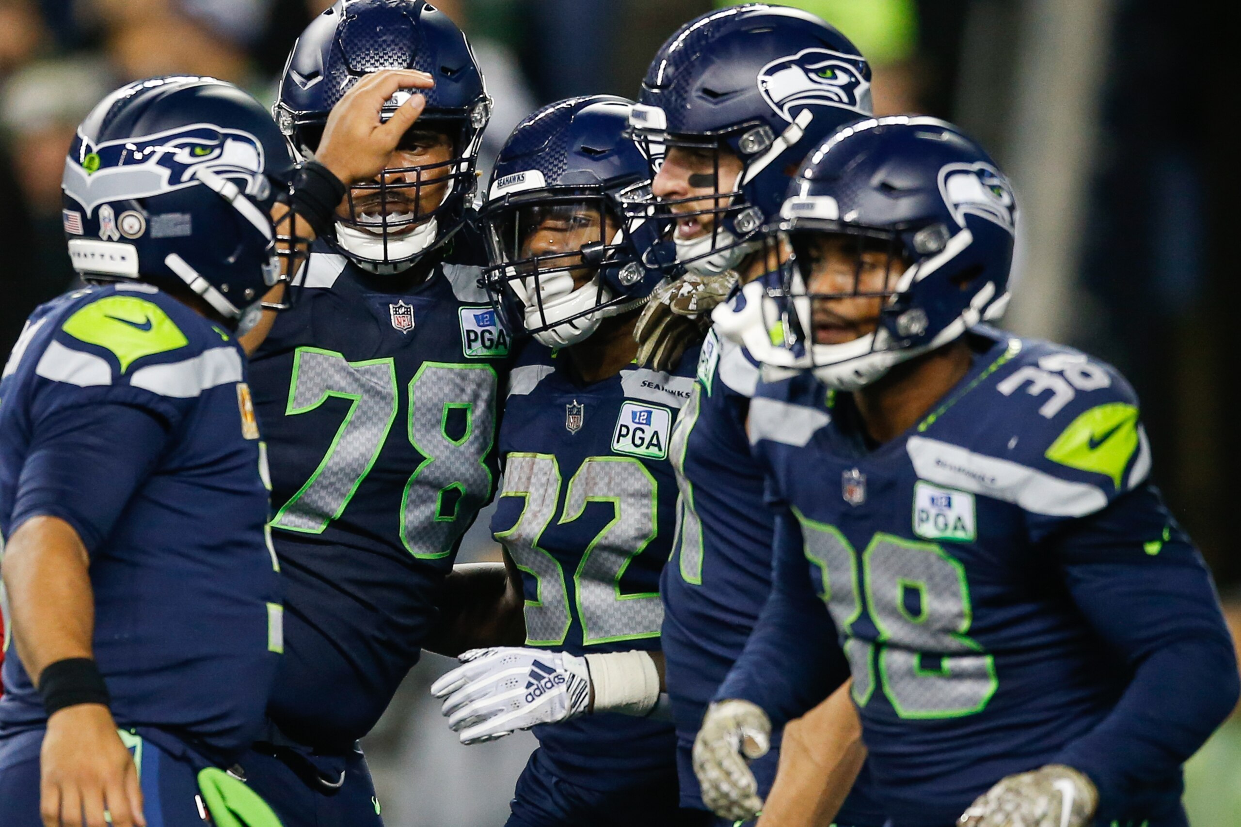 SEATTLE, WA - NOVEMBER 15: Chris Carson #32 of the Seattle Seahawks celebrates a second quarter touchdown with teammates against the Green Bay Packers at CenturyLink Field on November 15, 2018 in Seattle, Washington. (Photo by Otto Greule Jr/Getty Images)