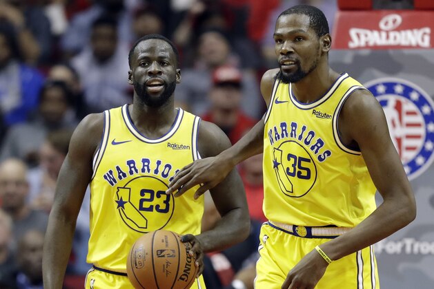 Golden State Warriors' Kevin Durant (35) pats Draymond Green (23) on the chest after a turnover during the second half of an NBA basketball game against the Houston Rockets Thursday, Nov. 15, 2018, in Houston. (AP Photo/David J. Phillip)