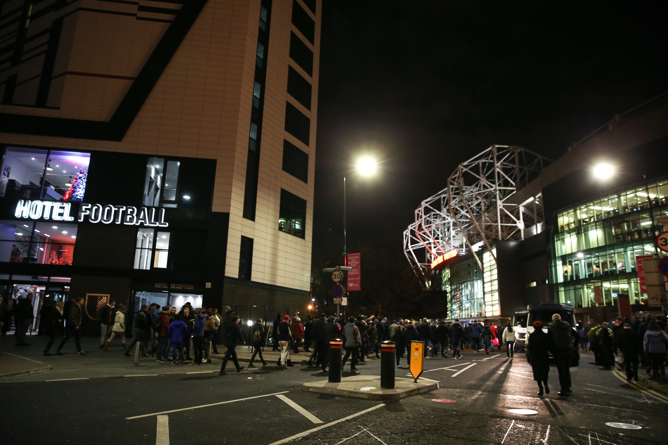 MANCHESTER, ENGLAND - NOVEMBER 24: Manchester United fans make their way past Hotel Football on their way to the stadium before the UEFA Europa League match between Manchester United FC and Feyenoord at Old Trafford on November 24, 2016 in Manchester, England. (Photo by Barrington Coombs/Getty Images)