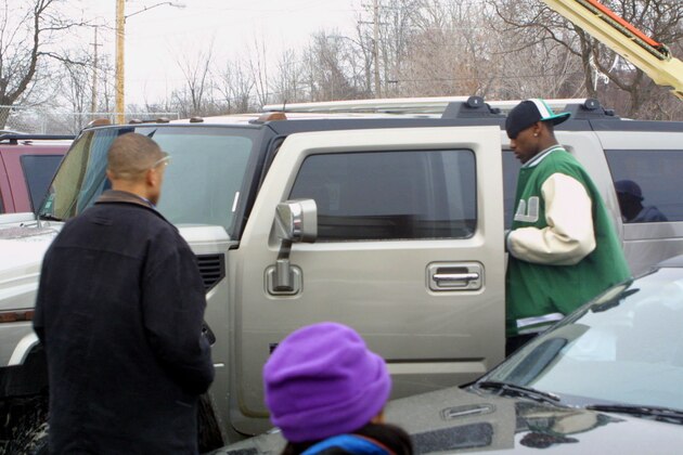 Akron St. Vincent-St. Mary basketball star LeBron James, right, gets into a new Hummer outside Warrensville Heights High School Saturday, Jan. 11, 2003. Where did LeBron James get the SUV? The high school sensation is driving a Hummer, a popular sports utility vehicle, his mother reportedly gave him for his 18th birthday.     Now high school officials are concerned James may have broken eligibility rules. (AP Photo/Michael Lilly)